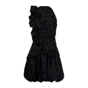 Black polka dot sleeveless mini dress with ruffle detailing and floral appliqué — the Tara Dress, a chic and eco-friendly A-line summer piece.