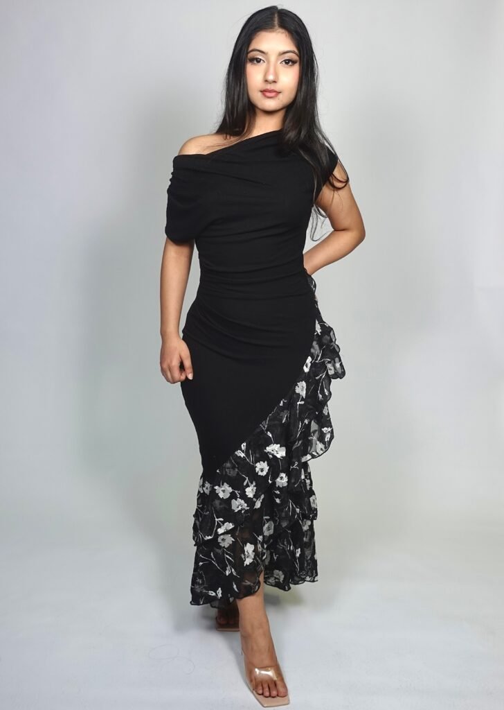 selene; "Women's black off-the-shoulder midi dress with ruched silhouette, asymmetrical floral chiffon ruffle hem, and elegant evening style." LOVE LOHINI DRESS, LOHINI